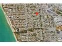 Aerial view showcases the neighborhood's layout, proximity to the beach, and residential homes, all connected by a grid of streets at 800 Riviera St, Venice, FL 34285