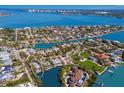 Expansive aerial view of a waterfront community with stunning bay views and lush landscaping at 3721 Flamingo Ave, Sarasota, FL 34242