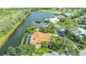 Expansive aerial view of a beautiful home on a waterfront property with a large screened-in lanai at 4221 Escondito Cir, Sarasota, FL 34238