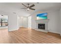 Inviting living room boasts a cozy fireplace, ceiling fan and flows into adjacent rooms at 7507 3Rd Nw Ave, Bradenton, FL 34209