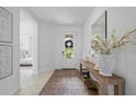 Bright entryway with tile floors, console table with decor, and a view into the bedroom at 1889 Saddlewood Cir, Port Charlotte, FL 33953
