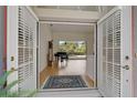 Inviting foyer with elegant French doors, piano, and an open view to the pool and screened-in lanai at 2173 Muskogee Trl, Nokomis, FL 34275