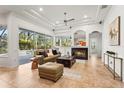 Open living room with fireplace and access to the screened lanai at 6815 Turnberry Isle Ct, Lakewood Ranch, FL 34202