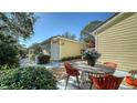 Cozy light yellow home featuring a charming backyard patio area, perfect for relaxing outdoors at 7628 Whitebridge Gln, University Park, FL 34201