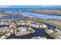 Stunning aerial view of waterfront homes surrounded by lush landscaping and tranquil waters with ocean view at 11124 Sanctuary Dr, Bradenton, FL 34209