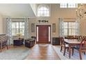 Welcoming foyer with high ceilings, wood flooring, and abundant natural light from large windows at 223 Heritage Isles Way, Bradenton, FL 34212