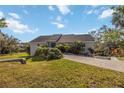 A spacious house with a long driveway and landscaping at 2458 Whippoorwill Cir, Sarasota, FL 34231