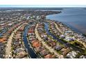 Aerial view of a waterfront community with canals and homes with docks and tile roofs at 579 Fore Dr, Bradenton, FL 34208