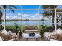 Relaxing screened lanai with comfortable seating and a stunning lake view at 6409 Moorings Point Cir # 102, Lakewood Ranch, FL 34202