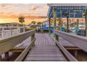 A scenic boat dock featuring ample seating, string lights, and stunning sunset views on the water at 903 20Th W Ave, Palmetto, FL 34221
