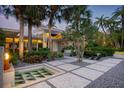 Striking home exterior with a water feature, modern walkway and lush landscaping at 117 S Polk Dr, Sarasota, FL 34236