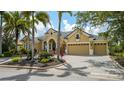 Stunning home featuring a manicured front yard, beautiful landscaping and a circular driveway at 13616 Legends Walk Ter, Lakewood Ranch, FL 34202
