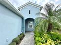 Welcoming entrance of this home with manicured landscaping and blue accent shutters at 3325 Azurite Way, Bradenton, FL 34211