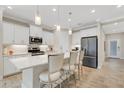 Modern kitchen with stainless steel appliances, white cabinets and a quartz countertop island at 3325 Azurite Way, Bradenton, FL 34211