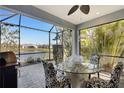 Relaxing screened patio with a BBQ, overlooking a serene pond, perfect for outdoor dining at 3325 Azurite Way, Bradenton, FL 34211
