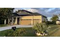 Inviting single-Gathering home with manicured lawn, boat on trailer, and an attached two-car garage at 15079 Wichita Rd, Port Charlotte, FL 33981