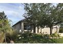 Inviting single-Gathering home with manicured lawn, rock accents, mature trees, and welcoming porch at 15079 Wichita Rd, Port Charlotte, FL 33981