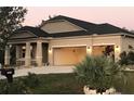 Stunning single-Gathering home shows a two-car garage with an inviting covered front porch at 15079 Wichita Rd, Port Charlotte, FL 33981