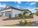 Beautiful single-Gathering home with an attached two-car garage, manicured landscaping, and a paved walkway at 3016 Formia Ct, Bradenton, FL 34211