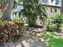 Beautiful exterior with lush landscaping, trees and shade to keep cool at 3500 El Conquistador Pkwy # 119, Bradenton, FL 34210