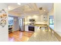 Modern kitchen with stainless steel appliances, granite countertops, and ample natural light from a window at 3500 El Conquistador Pkwy # 119, Bradenton, FL 34210