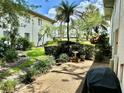 Outdoor patio with lush landscaping and a seating area for relaxation at 3500 El Conquistador Pkwy # 119, Bradenton, FL 34210