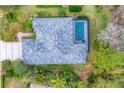 Aerial view of home showcasing roof, landscaping and screened in pool at 6669 Windjammer Pl, Lakewood Ranch, FL 34202