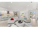 Bright, open-concept living room featuring a gourmet kitchen and dining area at 6669 Windjammer Pl, Lakewood Ranch, FL 34202