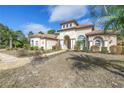 Charming home with a tile roof, arched entrance, and lush landscaping in a sunny residential neighborhood at 9709 Wilderness Trl, Weeki Wachee, FL 34613