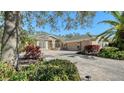 Beautifully landscaped home with a stone-accented facade and a well-manicured lawn, exuding elegance and charm at 12471 Natureview Cir, Bradenton, FL 34212