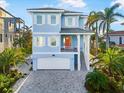 Inviting two-story home with a paved driveway and a two-car garage at 12917 42Nd W Ter, Cortez, FL 34215