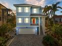 Charming two-story blue home with white shutters and a brick driveway at 12917 42Nd W Ter, Cortez, FL 34215