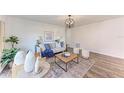 Bright living room featuring stylish decor, wood floors, modern lighting, and comfortable seating at 20032 Sancraft Ave, Port Charlotte, FL 33954
