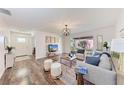 Bright living room with modern decor, wood floors, and views into the backyard at 20032 Sancraft Ave, Port Charlotte, FL 33954