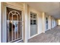 Entrance featuring a secure screen door and neutral tones, offering a glimpse of the interior at 4350 Chatham Dr # E106, Longboat Key, FL 34228