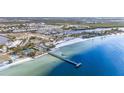 Aerial view of a beach, pier, and community at 559 Bahia Beach Blvd, Ruskin, FL 33570
