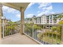 Relax on this balcony with lovely views of palm trees and nearby resort buildings on a sunny day at 559 Bahia Beach Blvd, Ruskin, FL 33570