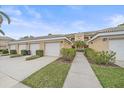 The exterior showcases a well-maintained lawn, manicured landscaping, and an attached single-car garage at 6334 Grand Oak Cir # 201, Bradenton, FL 34203