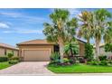 Charming home featuring a brick driveway, a tile roof, a two car garage and beautiful landscaping at 6814 Willowshire Way, Bradenton, FL 34212