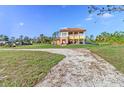 Two-story home with tile roof, balcony, and ample outdoor space at 8059 Strasse Blvd, Punta Gorda, FL 33982