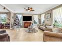 Bright living room featuring a ceiling fan, tile floors, and large windows at 8059 Strasse Blvd, Punta Gorda, FL 33982