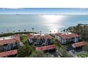 Stunning aerial view of waterfront condos with red tile roofs, lush landscaping, and panoramic ocean views at 3460 Wild Oak Bay Blvd # 145, Bradenton, FL 34210