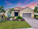 Charming single-story home featuring a well-manicured lawn with professional landscaping and a two-car garage at 5116 Tivoli Run, Bradenton, FL 34211