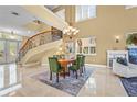 Elegant dining room featuring high ceilings, a grand staircase, marble floors and a decorative chandelier at 7460 Monte Verde, Sarasota, FL 34238