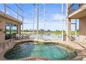 Relaxing indoor hot tub overlooking scenic golf course and waterfront views from the screened-in patio at 7460 Monte Verde, Sarasota, FL 34238