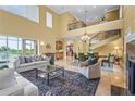 Bright, open-concept living space with a fireplace, staircase, and views of the outdoor scenery at 7460 Monte Verde, Sarasota, FL 34238