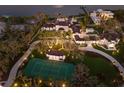 Expansive property with a tennis court, manicured grounds, and elegant architecture, ideal for outdoor enjoyment at 8501 Midnight Pass Rd, Sarasota, FL 34242