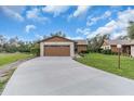 Inviting single-story home with a long driveway leading to a spacious two-car garage at 1817 Curry Ave # 57, Nokomis, FL 34275