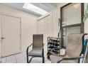 Relaxing covered patio area with tile flooring, seating and storage at 1817 Curry Ave # 57, Nokomis, FL 34275