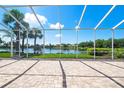 Relaxing screened patio area overlooking a tranquil lake and lush landscaping provides a serene outdoor space at 5521 Bilbao Pl, Sarasota, FL 34238